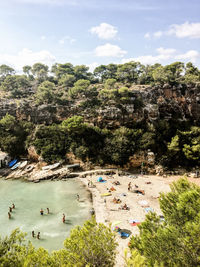 High angle beach view of sunny townscape against sky 