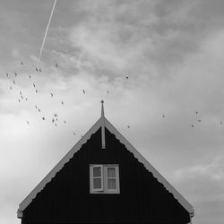 Low angle view of birds flying in sky