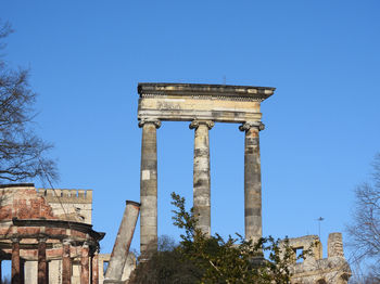 Low angle view of historical building against clear blue sky