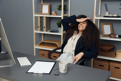 Sad businesswoman crying at desk