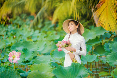 Full length of woman with pink flowers