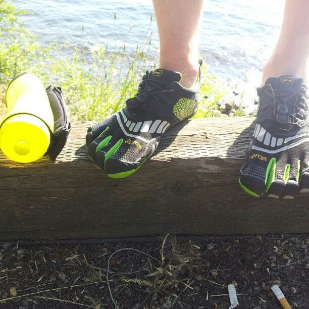 low section, person, lifestyles, human foot, shoe, leisure activity, standing, high angle view, part of, footwear, personal perspective, water, men, outdoors, day, barefoot