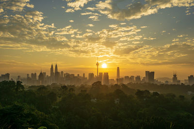 Buildings in city during sunset