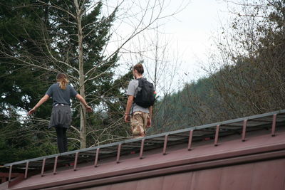 Low angle view of people standing on abandoned train