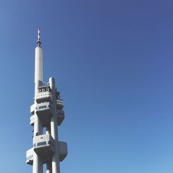 Low angle view of zizkov television tower against clear sky on sunny day