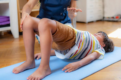 Physical therapy for kids, child doing a bridge with a physical therapist, core strengthening 