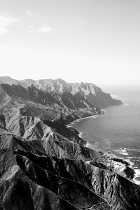 Scenic view of sea and mountains against sky