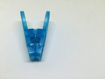 Close-up of blue over white background