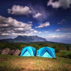 Scenic view of tent on field against sky