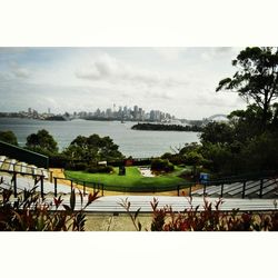 River in city against cloudy sky