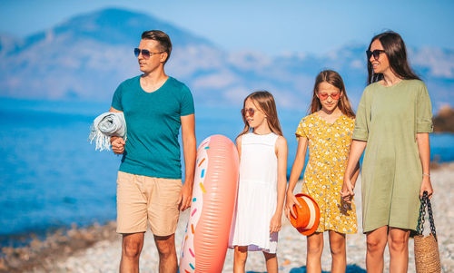 Family standing on beach