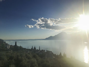 Scenic view of sea against bright sun