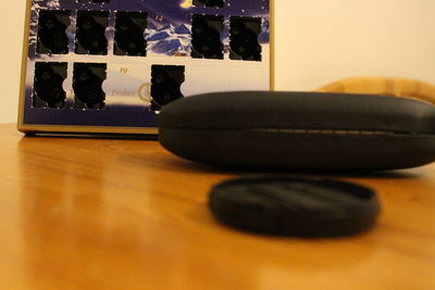 Close-up of black cat on table at home