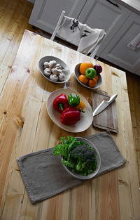 Fresh farmers tomatoes and basil on wood table.