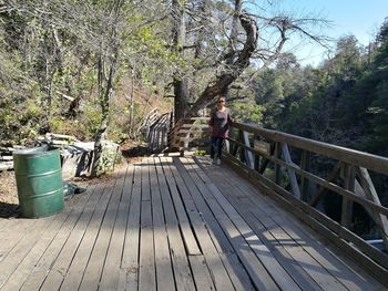 Man standing on footbridge