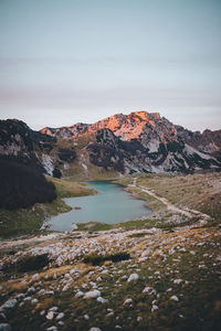 Scenic view of lake and mountains against sky