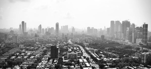 High angle view of modern buildings in city against sky