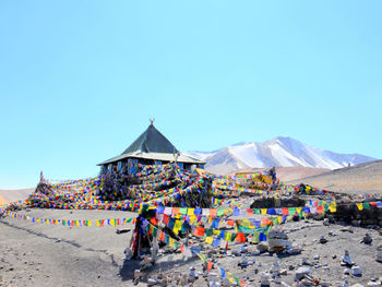 View of people on beach against blue sky