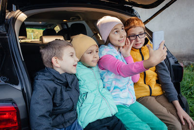 Portrait of smiling friends in car