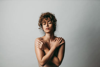 Portrait of beautiful young woman over white background