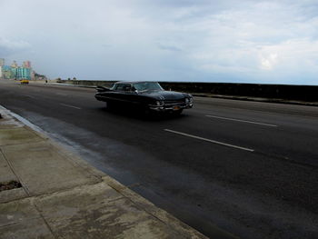 Cars on road against sky