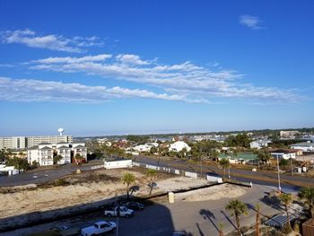 High angle view of town by sea against sky