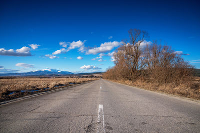 Empty road along countryside landscape