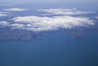 Aerial view of snowcapped mountains against sky