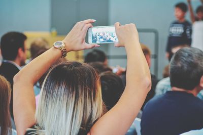 Rear view of people photographing