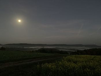 Scenic view of field against sky at night