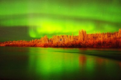 Scenic view of lake against sky at night