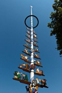 Low angle view of communications tower against clear blue sky