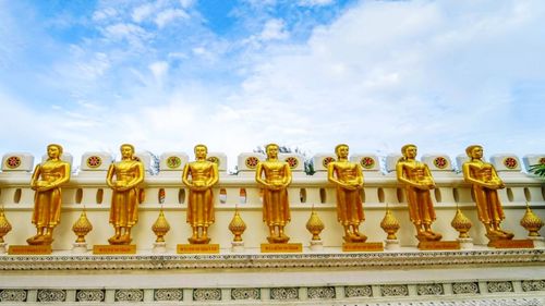 Low angle view of sculptures against sky