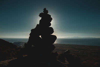 Stack of rock formation in sea against sky