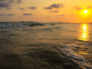 Scenic view of beach against sky during sunset