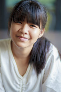 Headshot of asian teenager smiling face with relaxing mood