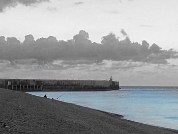 View of calm beach against sky