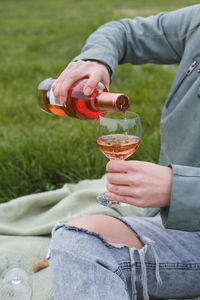 Midsection of man holding wineglass