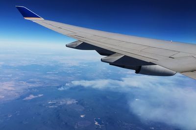 Cropped image of airplane flying over landscape