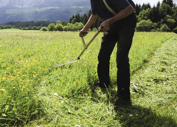 Low section of person standing on field