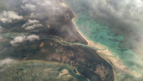 Aerial view of sea against cloudy sky
