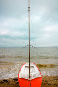 Sailboat on beach against sky