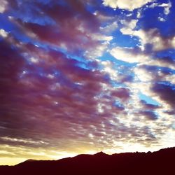 Scenic view of mountains against cloudy sky