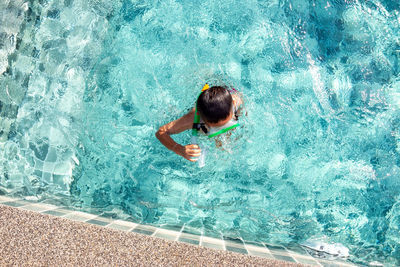 High angle view of boy swimming in pool