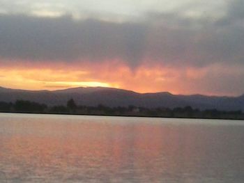 Scenic view of lake at sunset