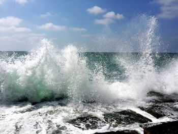 View of waves in sea against sky