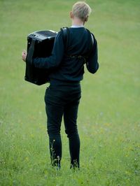 Rear view of man standing on field