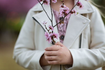 Midsection of woman holding bouquet