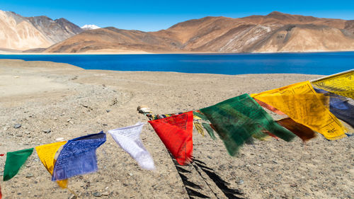 Himalayan prayer flags at pangong tso against mountain , leh , india