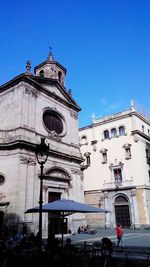 Low angle view of building against clear blue sky